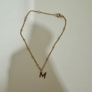 Gold toned M bracelet​​​​​​​​​​